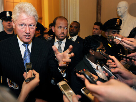 Former President Bill Clinton is mobbed by reporters after talking about health care during the Democrats' weekly caucus inside the Capitol Tuesday.