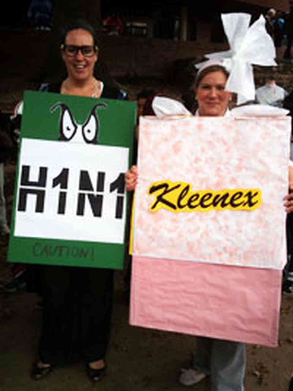 Women wearing H1N1 virus and Kleenex costumes get together for Halloween. Women wearing H1N1 virus and Kleenex costumes get together for Halloween.