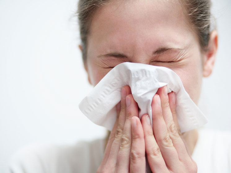 woman sneezing