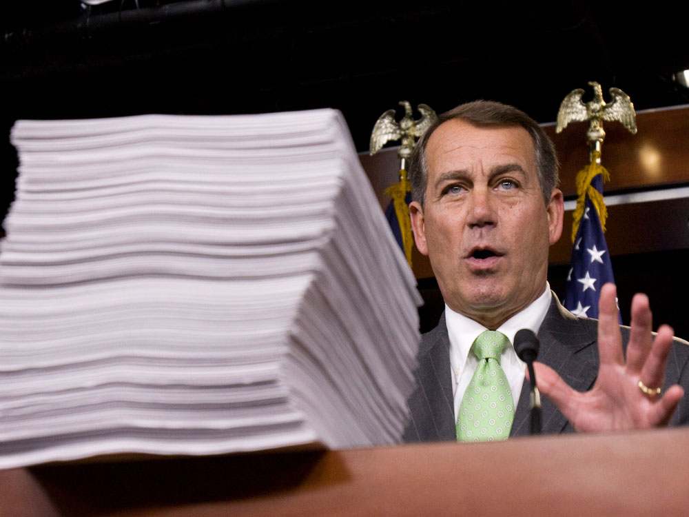 House Minority Leader John Boehner speaks behind a copy of the Democrat's version of the health care bill during a news conference on Capitol Hill in Washington, Thursday,  Oct. 29, 2009.