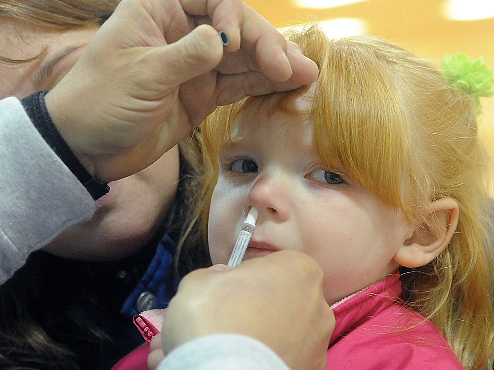 Three-year-old Abby Hilterbran receives a nasal vaccination in Piqua, Ohio, on Monday.