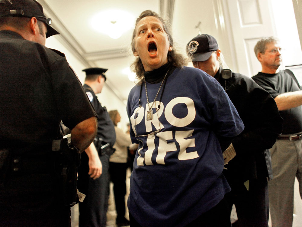 Anti-abortion protestor getting arrested.