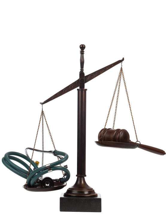 Scales holding a stethoscope in one side and a gavel in the other.
