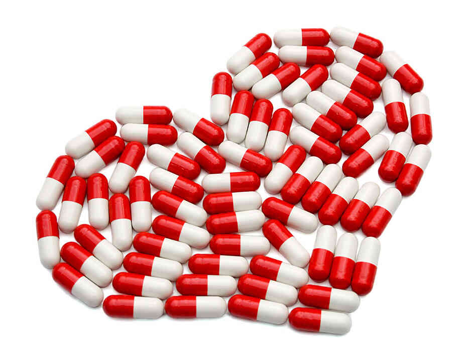 Pills arranged in the shape of a heart. Pills arranged in the shape of a heart.