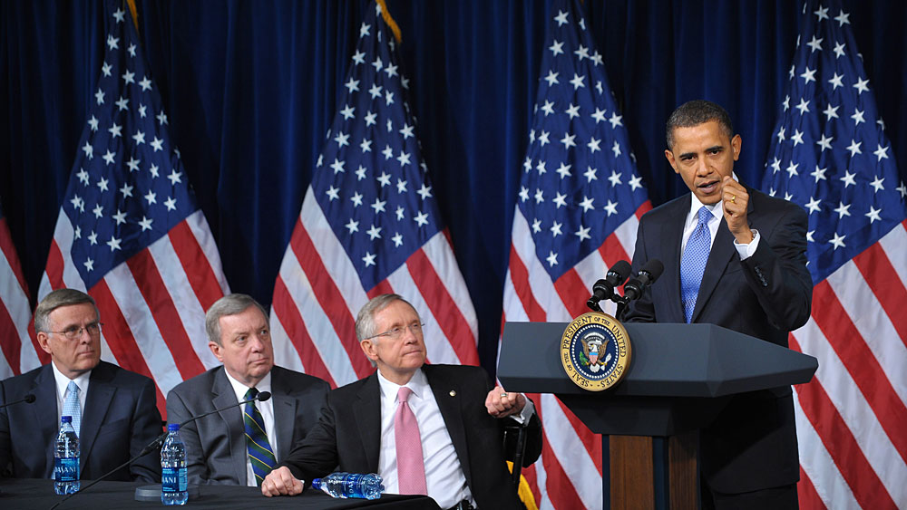 President Obama talks to Democratic senators at a party meeting in Washington, D.C.
