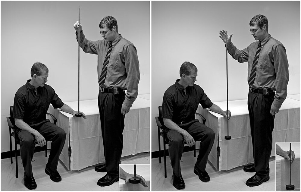 A researcher tests a subject's reaction time by having him catch a weighted stick.