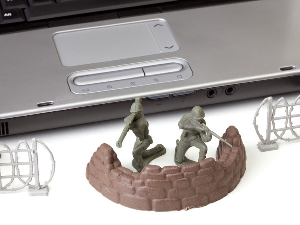 Toy soldiers in front of a laptop.