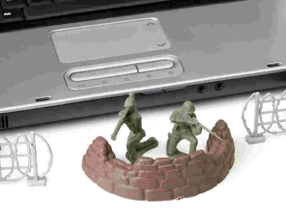 Toy soldiers in front of a laptop.