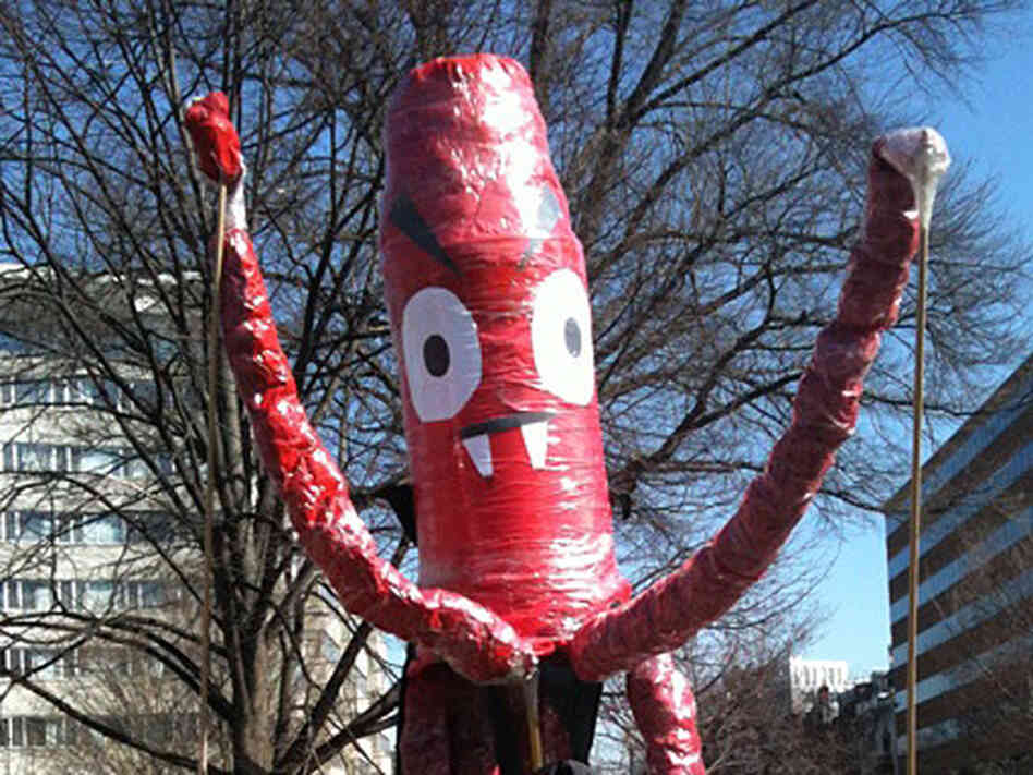 A 'vampire squid' marches outside a meeting of insurance executives. A 'vampire squid' marches outside a meeting of insurance executives.