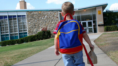 Preschool walking towards school.