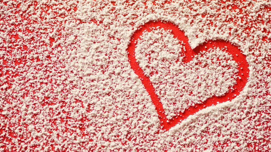 Heart traced in sugar on table.