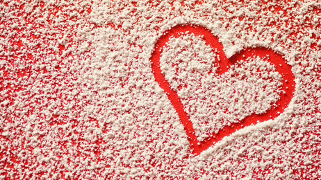 Heart traced in sugar on table.