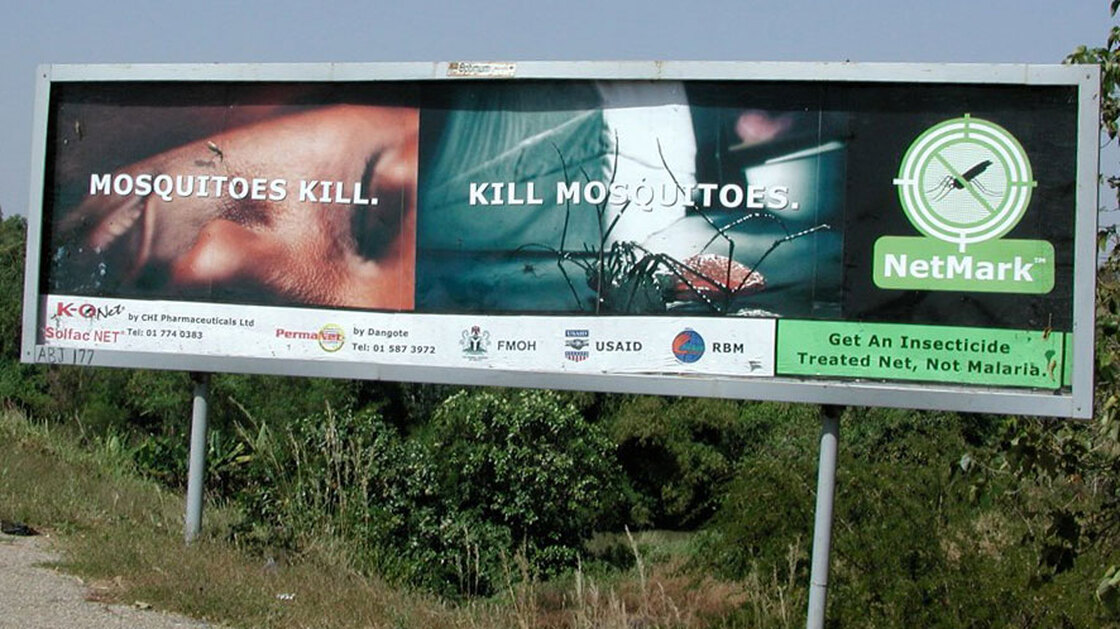 Roadside billboard in Nigeria promotes insecticide-treated nets for malaria prevention.