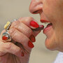 Older woman puts vitamin tablet in her mouth. Older woman puts vitamin tablet in her mouth.