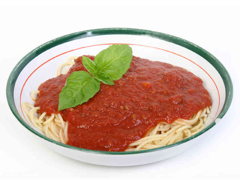 Bowl of pasta with sauce and basil