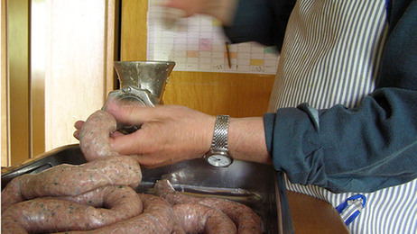 A man captures the process of putting together hand-made sausage.