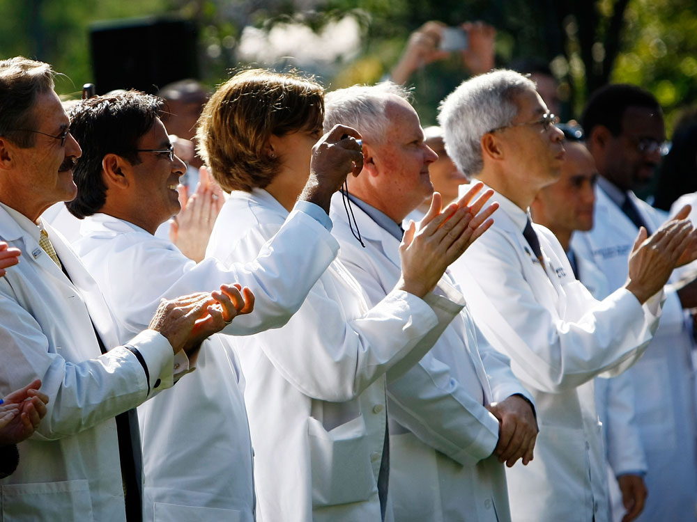 Doctors applaud President Obama.