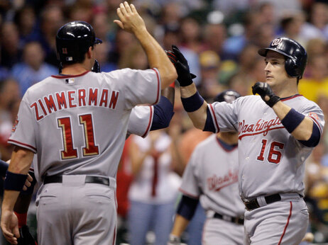 Ryan Zimmerman high-fives teammate Josh Willingham. Morry Gash/AP Photo