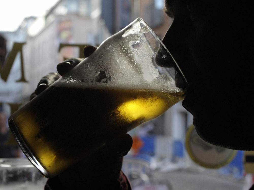 A man drinks a pint.