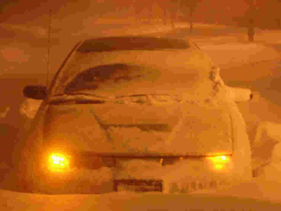Snowbound car stuck in the middle of the road in Deerfield, Ill. 