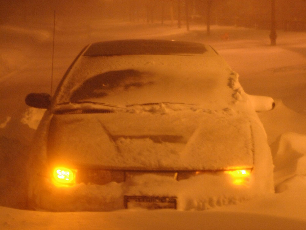 Snowbound car stuck in the middle of the road in Deerfield, Ill. 