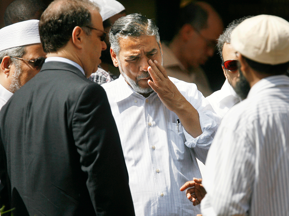 Omar Abu Ali, center, surrounded by supporters and his son Ahmed Omar Abu Ali's defense. Credit: AP Photo/Jacquelyn Martin/AP.