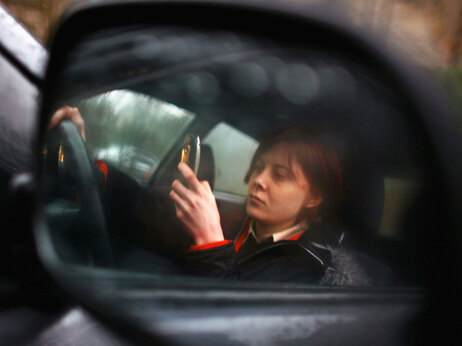 In this photo illustration a woman uses her mobile phone, on February 27, 2007 in Glasgow, Scotland. Photo by Jeff J Mitchell/Getty Images.
