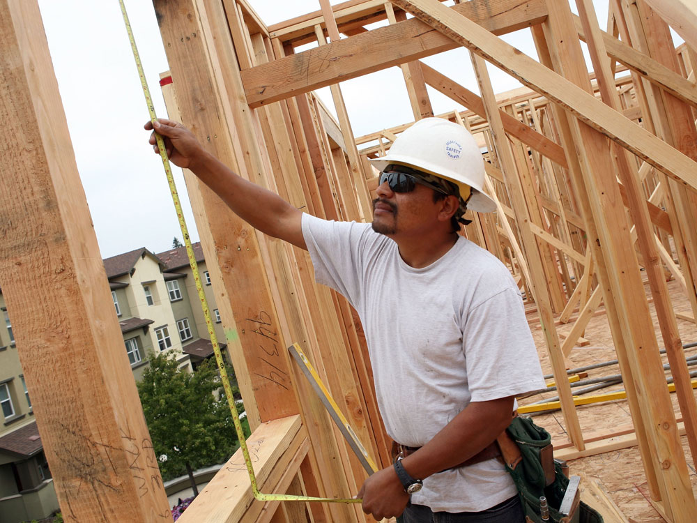 A construction worker measures a window as he works on a new home at the Olson Homes Garden Walk development June 16, 2009 in Hayward, California. Credit: Justin Sullivan/Getty Images.