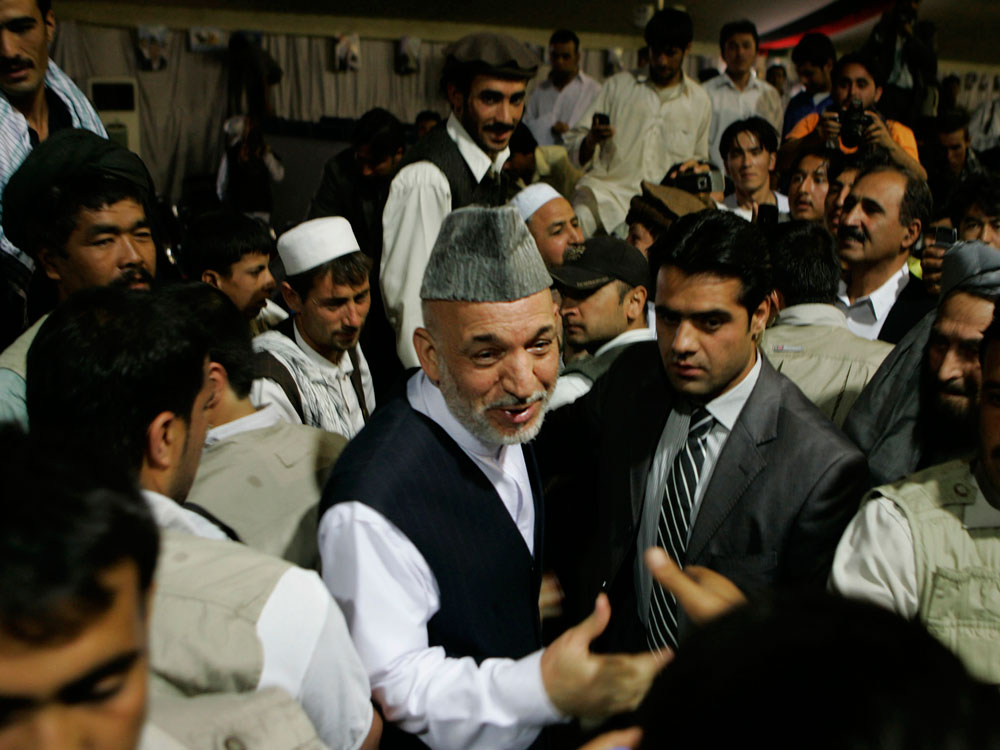 Presidential candidate and current President Hamid Karzai center, greet his supporters during an election rally in Kabul, Afghanistan, Friday, July 24, 2009. Credit: Rafiq Maqbool/AP.