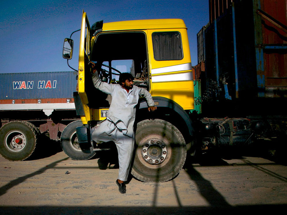 Driving a truck in Afghanistan is a is a dangerous but lucrative business. Truck drivers making deliveries to U.S. bases are often stopped and threatened by Taliban insurgents and in worse cases are killed doing their jobs. (David Gilkey/NPR)