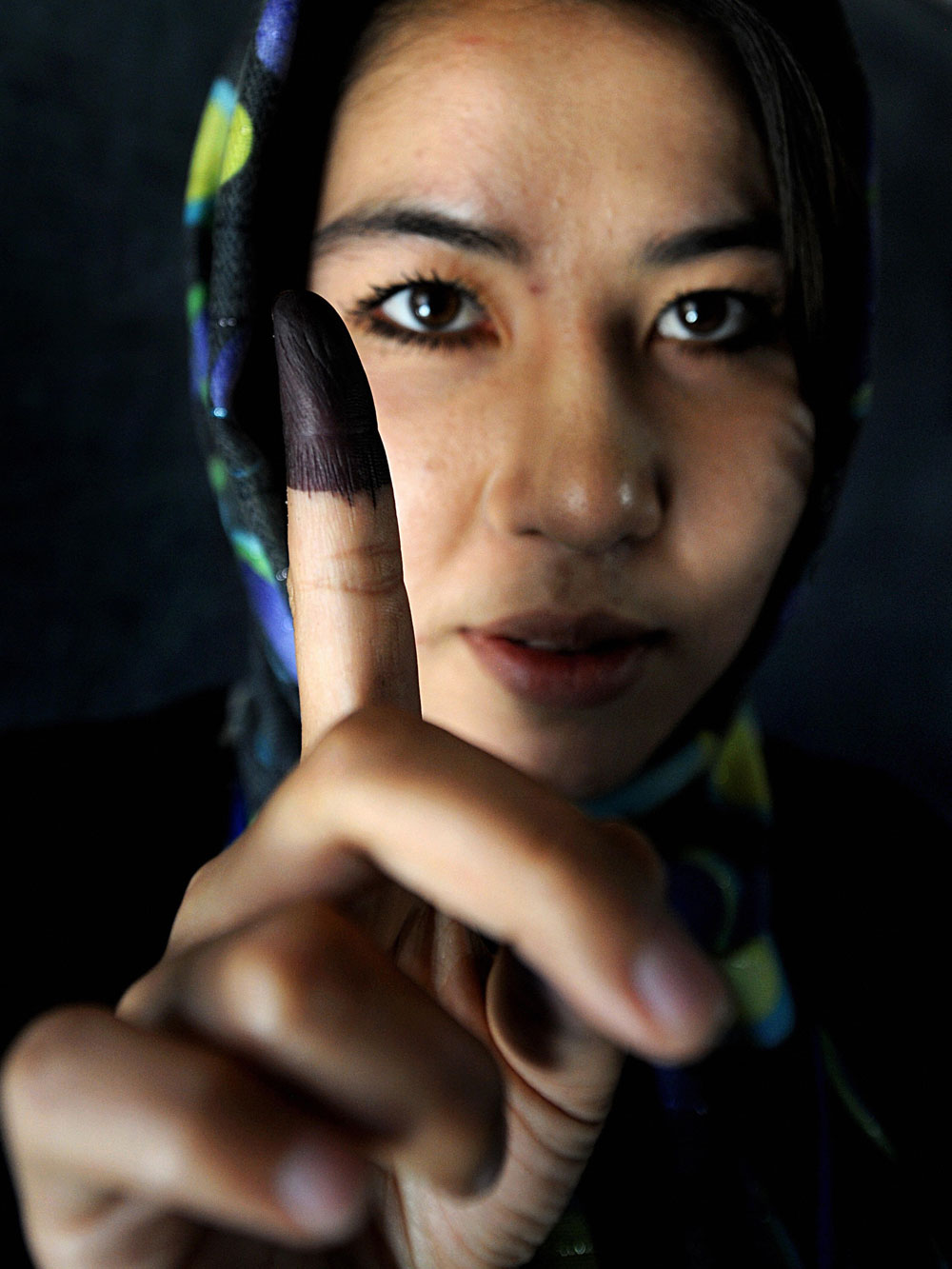 An Afghan girl displays her finger marked with indelible ink after casting her vote at a polling station in Kabul on August 20, 2009.  (Shah Marai/AFP/Getty Images)