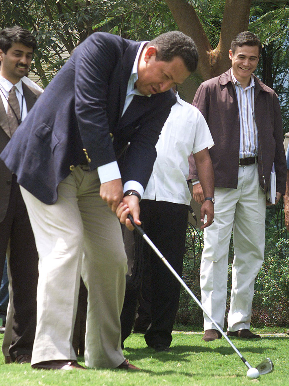Venezuelan President, Hugo Chavez, attempts to strike a golf ball during his visit to the Infosys campus near Bangalore, India, Monday March 7, 2005. (AP Photo)