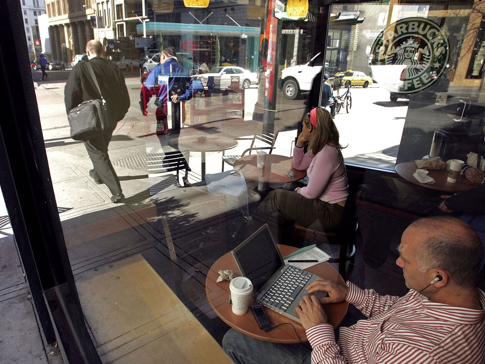 SAN FRANCISCO - JANUARY 24, 2006:  Adam Sold types as he uses wireless internet access at a Starbucks Coffee establishment. (Photo by Justin Sullivan/Getty Images)
