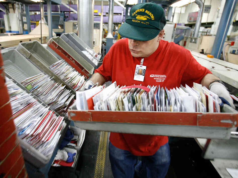 postal service worker processes mail. postal service worker processes mail.