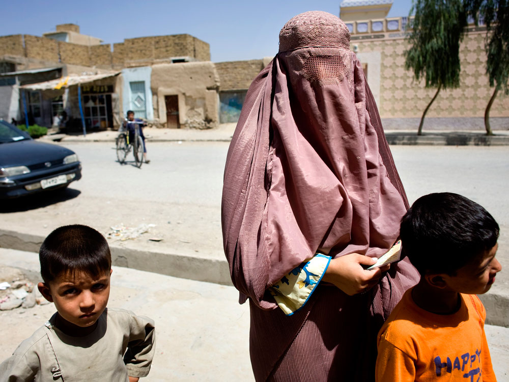 Sapnah, 21, had been looking for a women's polling station for 20 minutes with her two small boys in Kandahar, Afghanistan, Thursday, Aug. 20, 2009. She said her family did not know that she had come out to vote, but that she was registered for the election and wanted to vote for Karzai. Fear of Taliban attacks kept many women at home during Afghanistan's presidential and provincial council elections. (Holly Pickett/NPR)