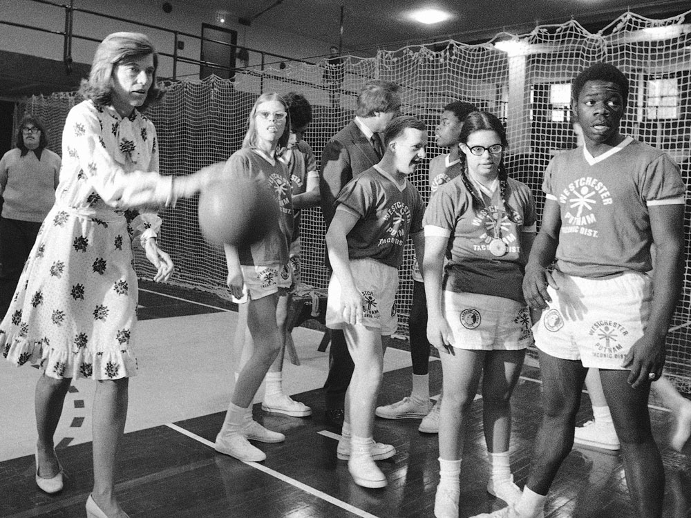 In this Feb. 28, 1975, file photo, Eunice Kennedy Shriver, left, plays basketball in with developmentally disabled children from the Margaret Chapman School in Hawthorne, N.Y. Shriver founded the Special Olympics. (AP Photo/Marty Lederhandler, File)
