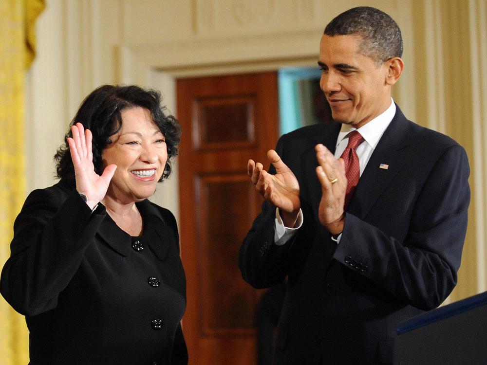 President Barack Obama applauds as Justice Sonia Sotomayor waves at the crowd as they arrive for a reception in the honor of Justice Sotomayor in the East Room at the White House on August 12, 2009 in Washington,DC. (Jewel Samad/AFP/Getty Images)