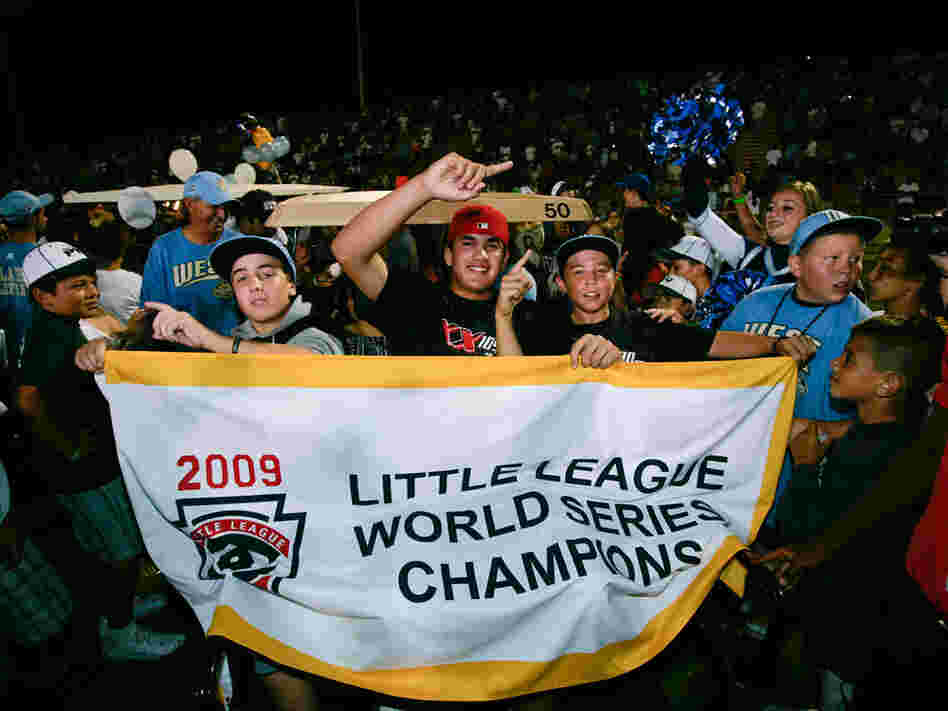 Aug. 31: Chula Vista, Calif., little league baseball players hold up a championship banner at a rall
