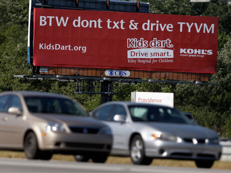 A bill board that encourages people not to text while they drive is shown in the northside of Indianapolis, Thursday, Sept. 17, 2009. (AP Photo/Michael Conroy)