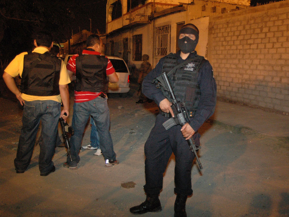 Police stand outside of a drug rehabilitation center after gunmen broke in, lined people against a wall and shot at least 17 dead, in Ciudad Juarez, on the Mexico's border with the U.S., late Wednesday Sept. 2, 2009. Authorities had no immediate suspects or information on the victims. (AP Photo)