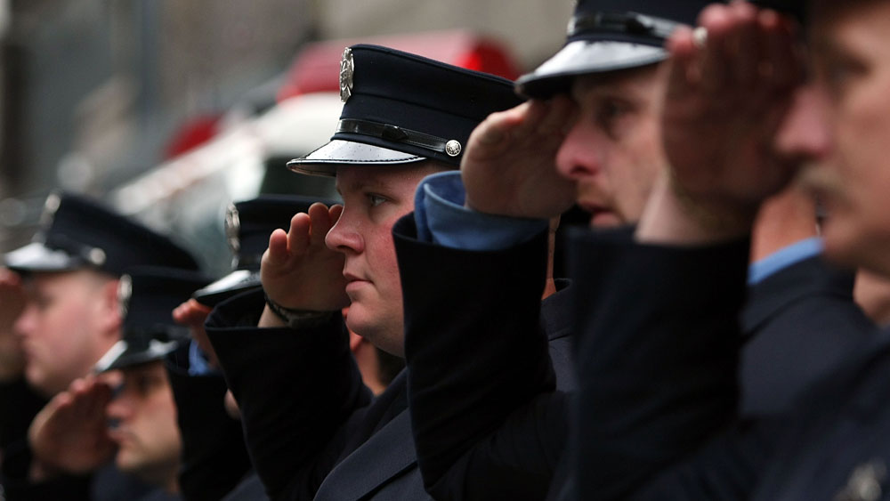 NEW YORK - SEPTEMBER 11:  Firefighters from Manhattan's Engine 7 Ladder 1 salute during a moment of silence marking the World Trade Center attacks September 11, 2007 in New York City. (Photo by Mario Tama/Getty Images) 