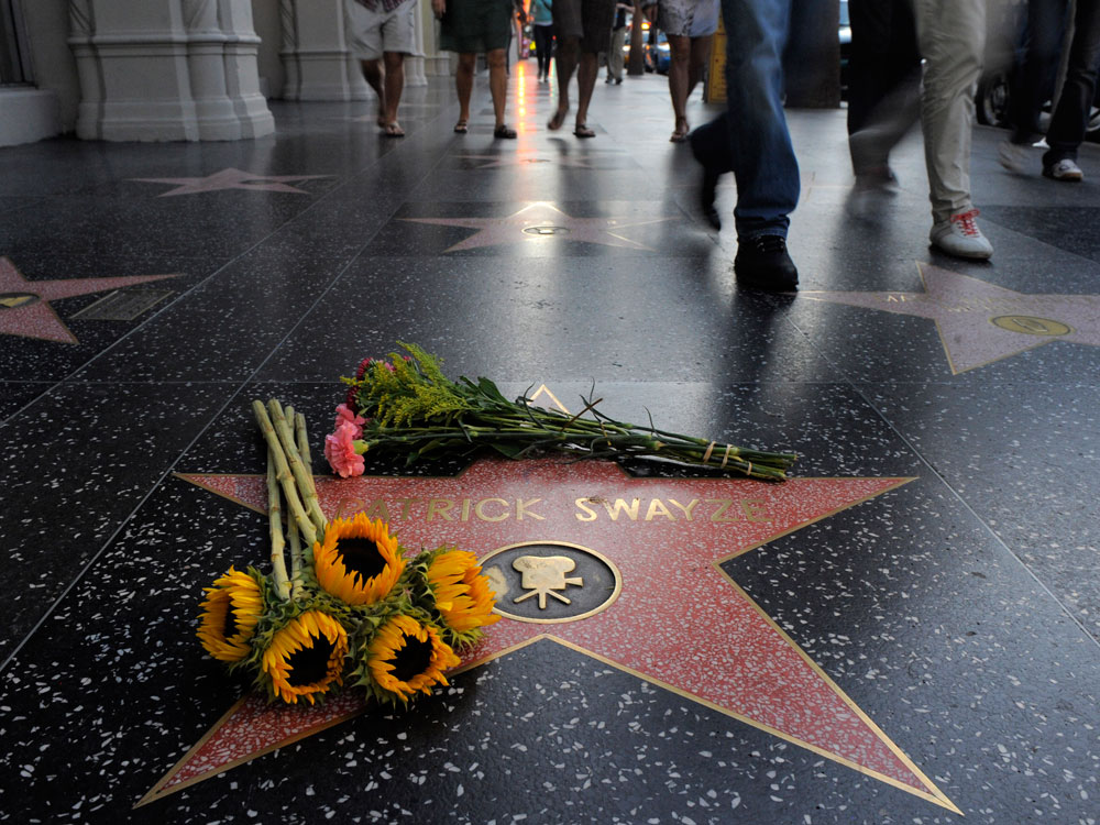 Flowers decorate Patrick Swayze's star on the Hollywood Walk of Fame in Los Angeles, Monday, Sept. 14, 2009. Swayze, died Monday after a battle with pancreatic cancer. He was 57. (AP Photo/Jae C. Hong)