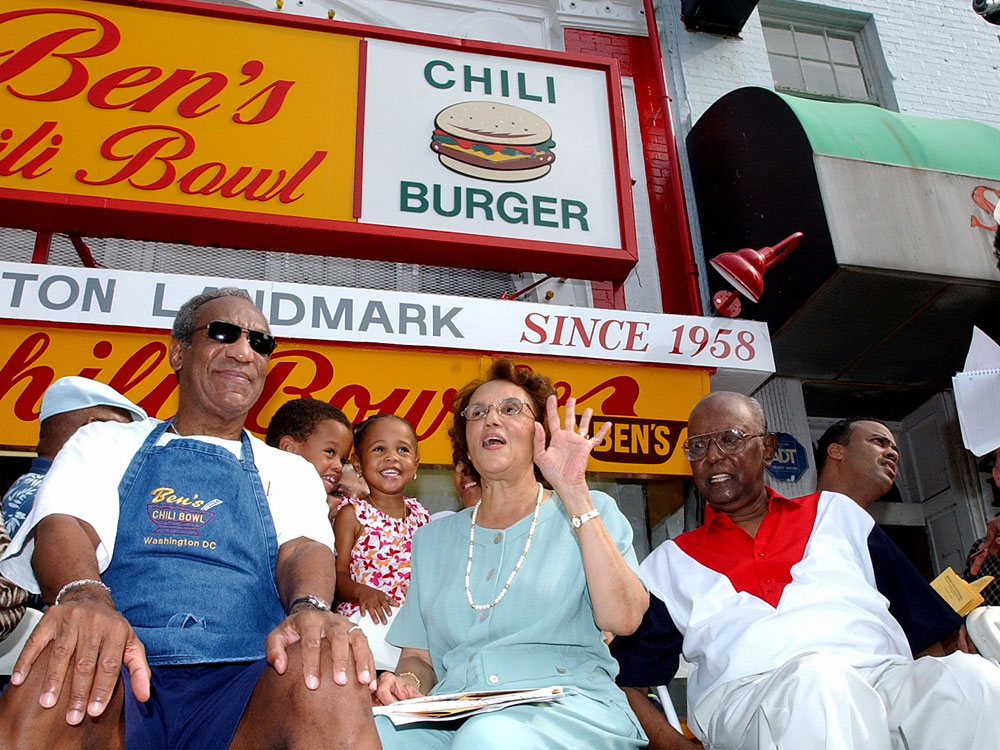 Comedian Bill Cosby, left, joins Ben Ali, right, and Ali's wife, Virginia during a celebration on the 45th anniversary of Ben's Chili Bowl Restaurant in Washington Friday, Aug. 22, 2003. (AP Photo/Dennis Cook)