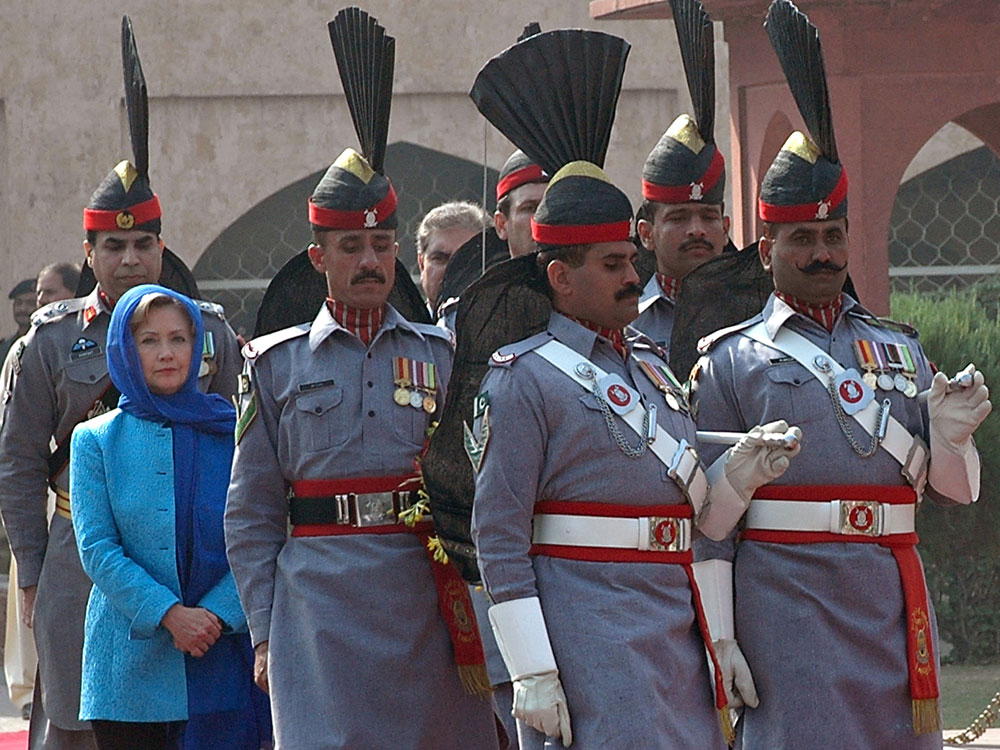 Secretary of State Hillary Clinton is escorted by Pakistan Rangers as she arrives at the tomb of Pakistan's national poet Allama Mohammad Iqbal during her visit to Lahore on October 29, 2009. (STR/AFP/Getty Images)
