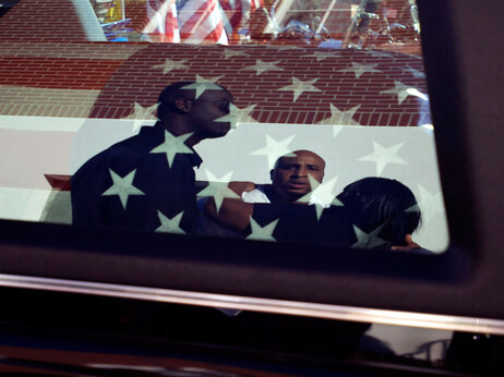 Friends and family members watch the casket of Staff Sgt. Vernon Martin being loaded into a hearse outside St. John's Baptist Church after his funeral service on October 19, 2009 in Savannah, Georgia. Martin, 25, of Savannah was one of eight U.S. soldiers killed Oct. 3 during a fierce battle at Combat Outpost Keating in Afghanistan.(Photo by Stephen Morton/Getty Images)