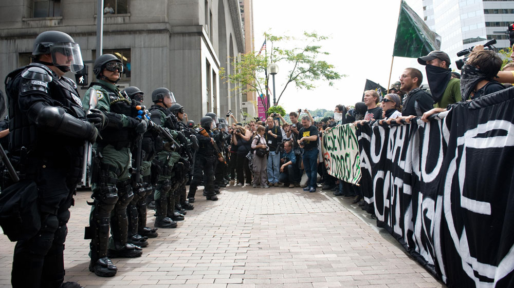 Demonstrators rally across from riot police prior to marching through downtown Pittsburgh, Pennsylvania, September 25, 2009, to protest the G20 economic summit. (Saul Loeb/AFP/Getty Images)