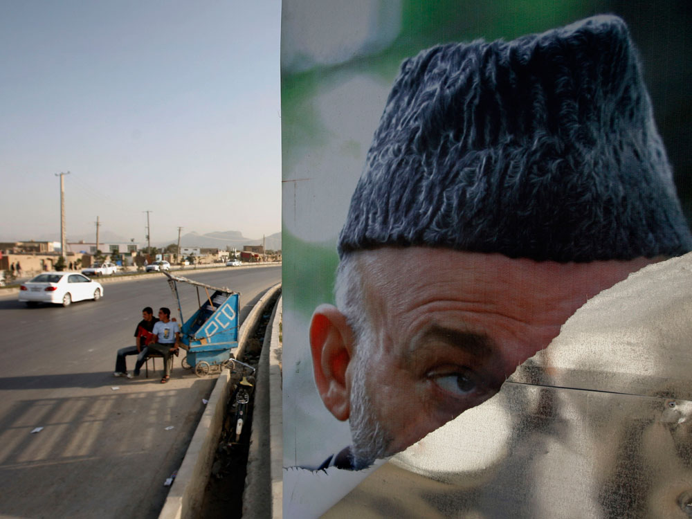 A torn and defaced election poster of Afghan President Hamid Karzai, who is a presidential candidate is seen in Kabul, Afghanistan on Saturday, Sept. 12, 2009. (AP Photo/Musadeq Sadeq)