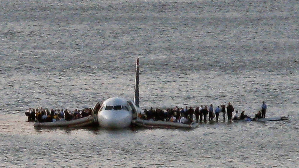 In this Thursday Jan. 15, 2009 file photo, airline passengers wait to be rescued on the wings of a US Airways Airbus 320 jetliner that safely ditched in the frigid waters of the Hudson River in New York, after a flock of birds knocked out both its engines. (AP Photo/Steven Day)** 