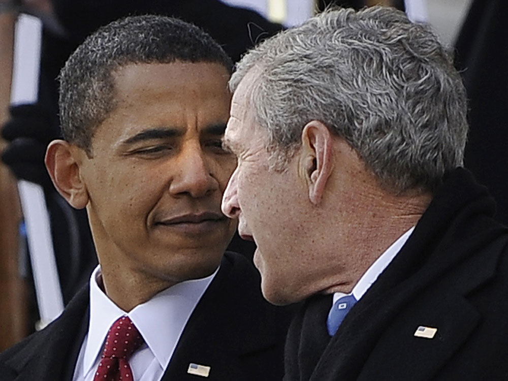 President Barack Obama escorts former George W. Bush as the former president leaves the US Capitol in Washington, DC, on January 20, 2009, following the inauguration of Obama as 44th US President. (Jim Watson/AFP/Getty Images)  