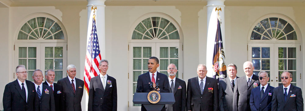 President Barack Obama, flanked by members of Troop A, First Squadron, 11th Armored Combat Regiment, speaks in the Rose Garden of the White House in Washington, Tuesday, Oct. 20, 2009, during a ceremony honoring their service with the Presidential Unit Citation for their actions during the Vietnam War. (AP Photo/Haraz N. Ghanbari)